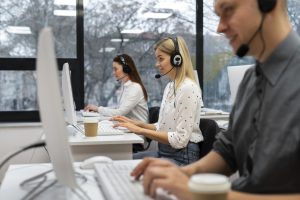 colleagues-working-together-call-center-office-with-coffee (Medium)